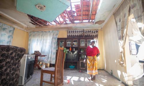A woman assesses damage to her home caused by tropical storm Filipo in Morrumbene district, Inhambane province, Mozambique.