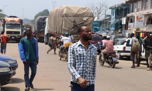 People and trucks cross at the Ghana-Côte d'Ivoire border at Elubo.
