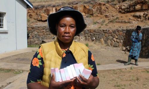A Village Health Worker holds a pack of oral contraceptives at a health facility in Mokhotlong, where community-based distribution plays a vital role in improving access to family planning services.