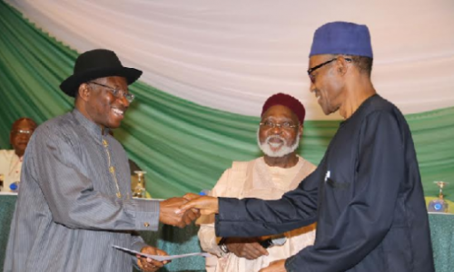 Former Nigerian President Goodluck Jonathan (left) and President-elect Muhammadu Buhari shake hands. In the middle is former head of state, Gen (Rtd) Abdulsalam Abubakar.