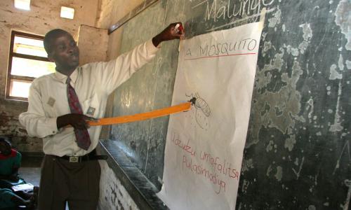 In Malawi, children learn about malaria and mosquitoes in school classes. A teacher explains about mosquitoes and malaria. Photo: WHO
